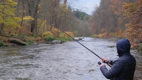 a man is fishing in a mountain river in the usa fishing is a hobby a man is fishing in a mountain river in the usa fishing is a hobby