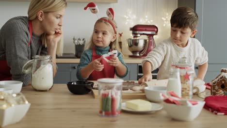 Mid-shot-video-of-family-cutting-out-gingerbread-cookies