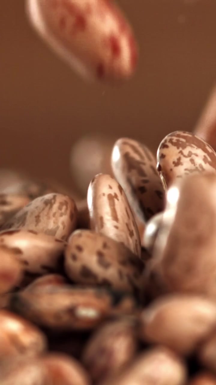 Macro Shot of Dry Pinto Beans Falling in Slow Motion