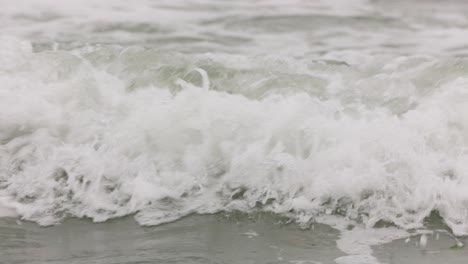 foamy waves splashing on the seacoast. close up