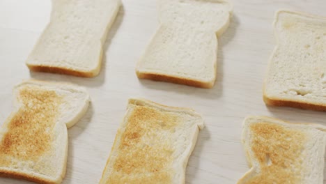 video of differently baked toasts seeing from above on wooden worktop