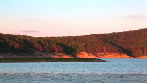 View of a lake during the golden hour with calm waters