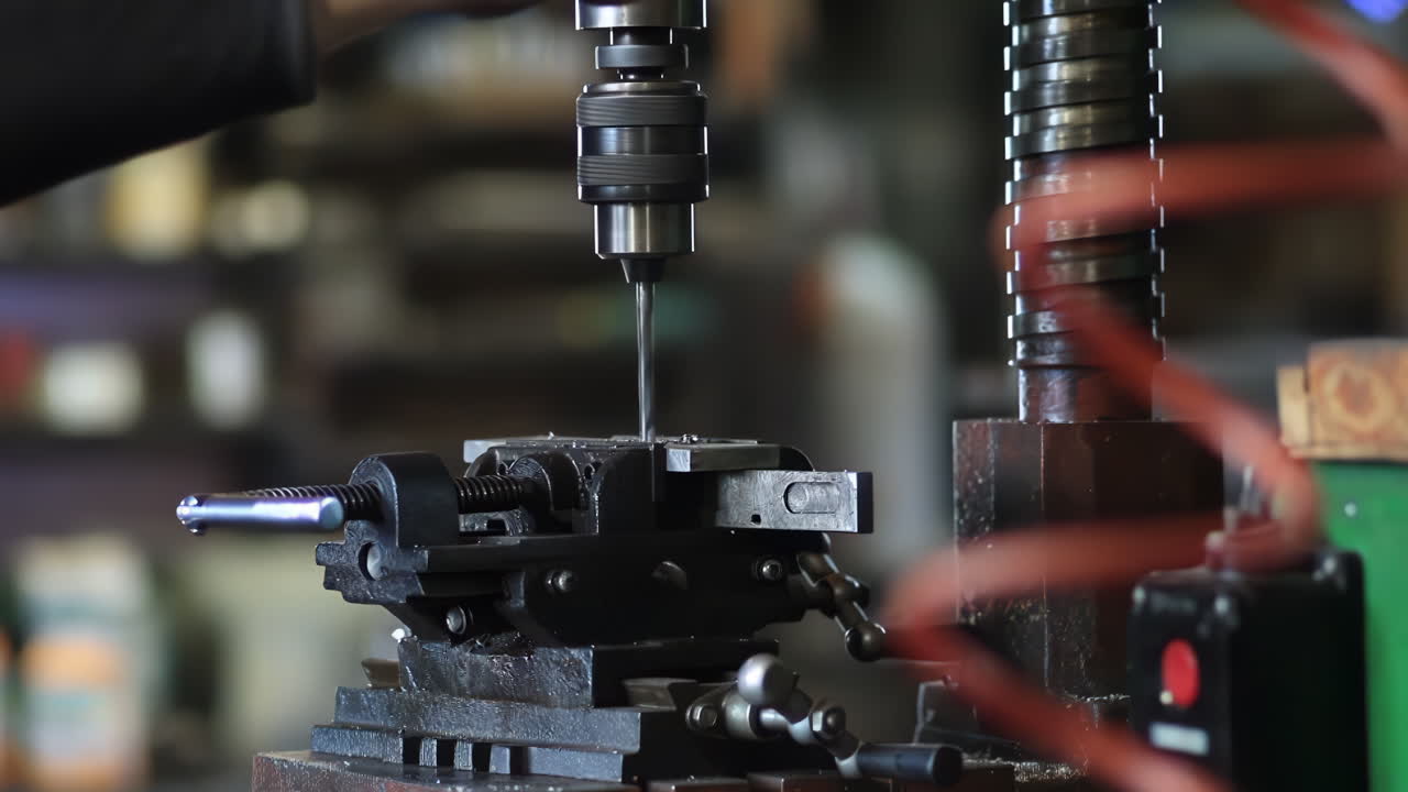 Skilled machinist working intently on a large industry in metal factory workshop with Large Machines