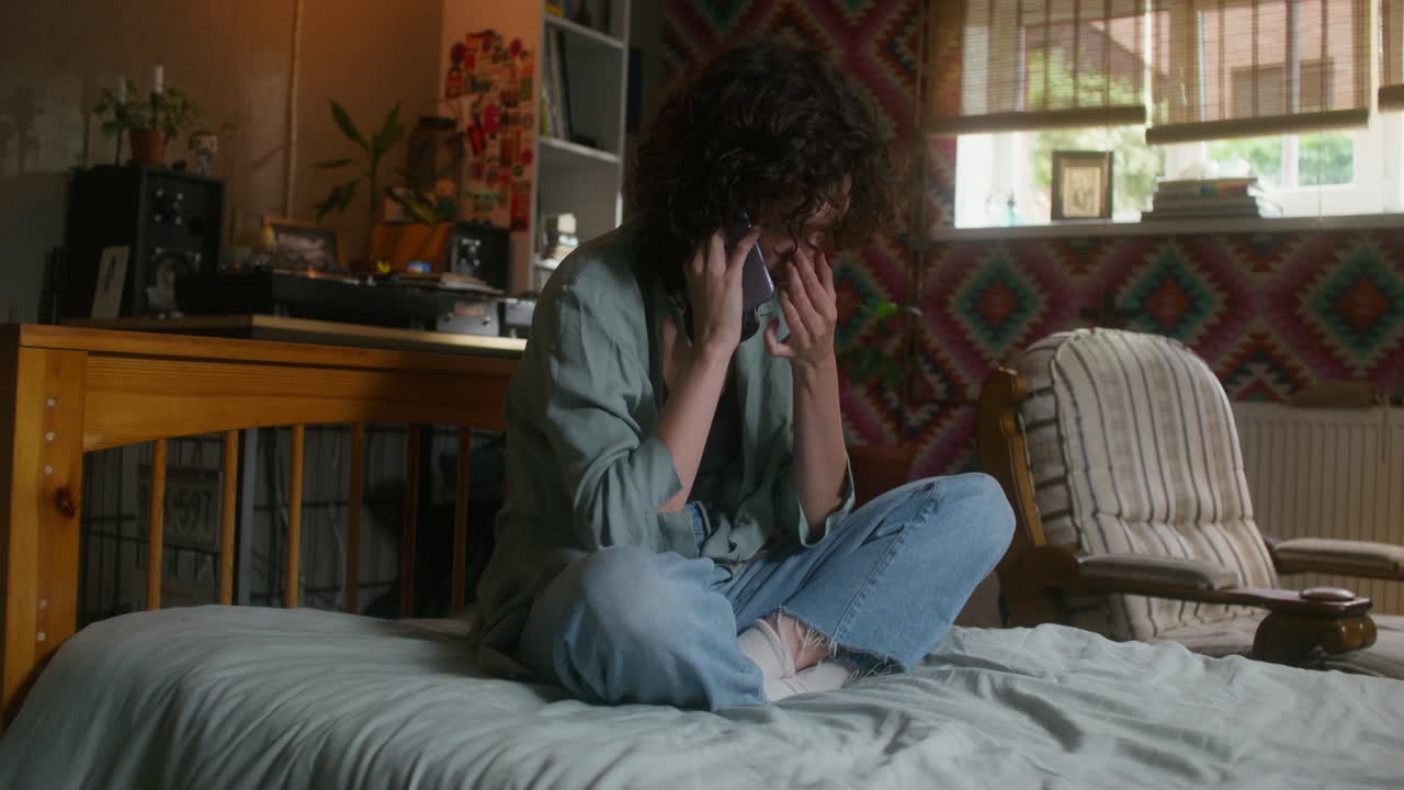 침실에서 전화로 얘기하는 여자