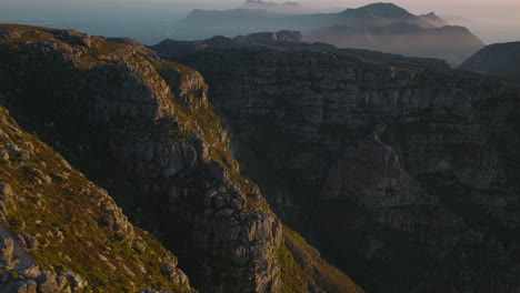 Rock-mountain-landscape-at-golden-hour.-Fly-above-national-park,-ridges-and-high-rock-walls.-Cracked-stone-blocks.-Cape-Town,-South-Africa