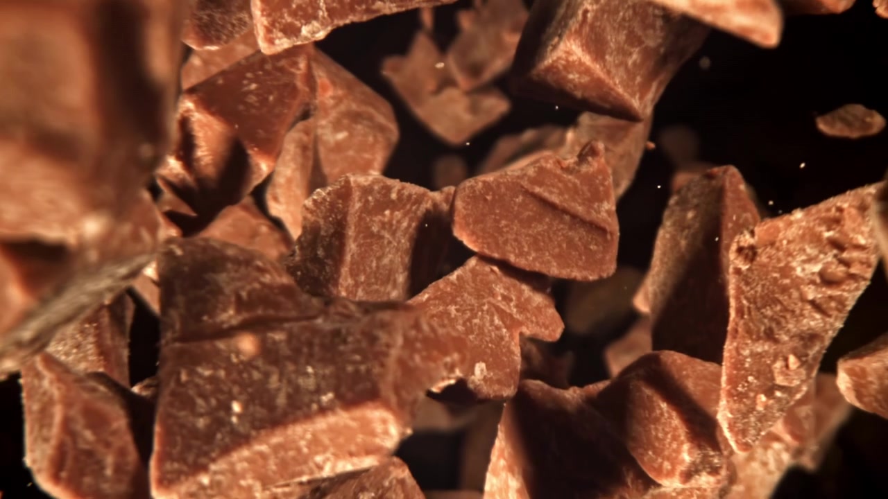 Slow Motion of Chocolate Chunks Falling on a Black Background