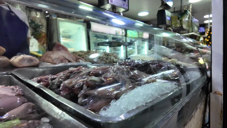 tracking shot revealing a variety of fresh octopus, squid and fish on crushed ice at the Chacao Municipal Market, Caracas Venezuela