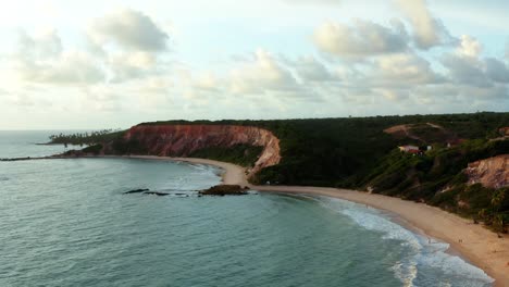 beautiful aerial drone rising shot of the large tropical colorful cliffs on the exotic beach of tabatinga in northern brazil near joao pessoa on a warm summer day