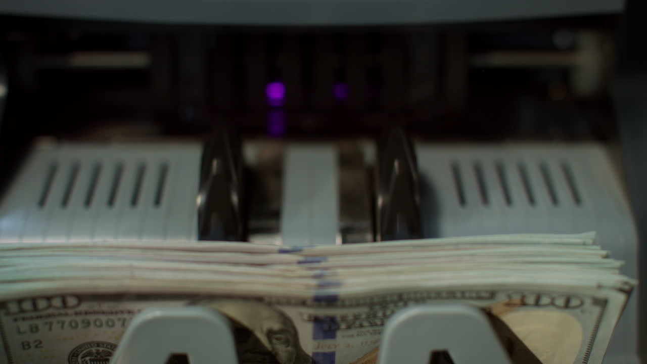 Us dollars banknotes on currency counter machine. Paper money calculation