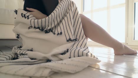 close view woman covered with blanket rests at window