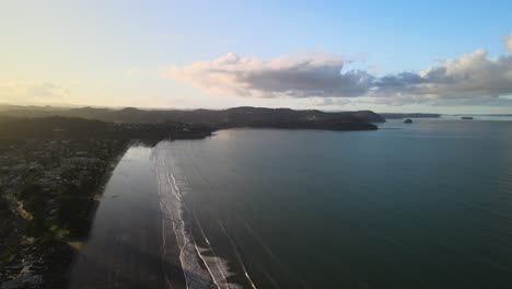 sunset seen from the sky by drone in orewa beach, new zealand