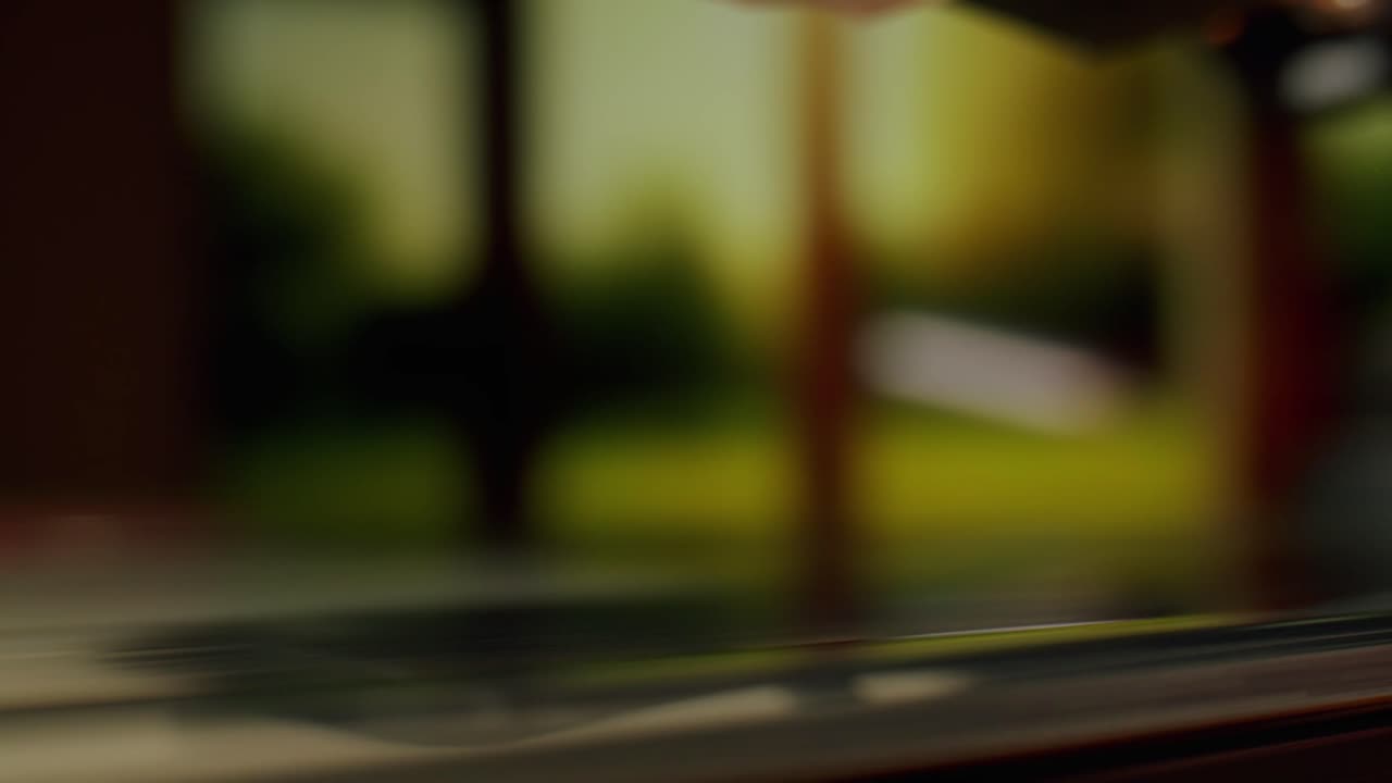 Close Up of Turntable Needle Dropping onto Spinning Vinyl Record