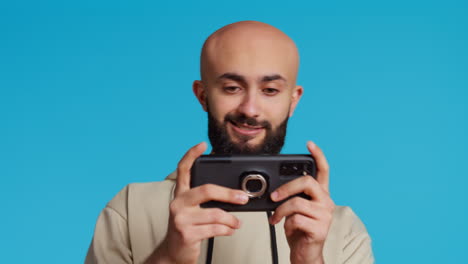 middle eastern guy enjoying video games contest on camera