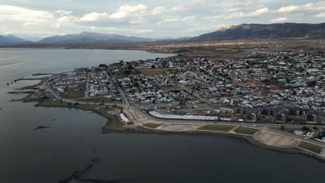 cityscape of puerto natales chilean patagonia, aerial view of city, port and summer horizon, montt gulf in antarctic region