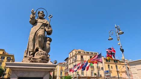 statue with waving flags in sorrento, italy