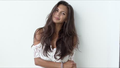 sensual brunette in white dress looking at camera