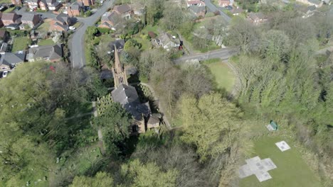 aerial view of a church and graveyard in a residential area