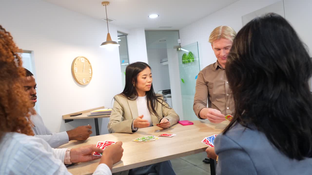 Group of People Playing Cards at a Table