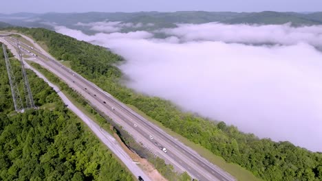 Clouds-and-fog-along-with-traffic-on-Interstate-75-near-Jellico,-Tennessee-in-the-Cumberland-Mountains-with-drone-video-stable-wide