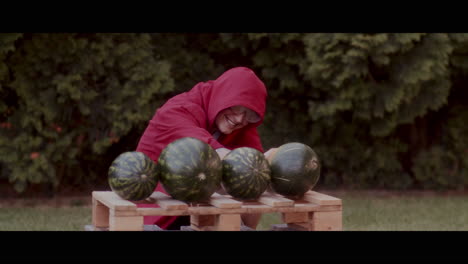 man playing with watermelons