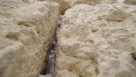 prayers tucked into the western wall