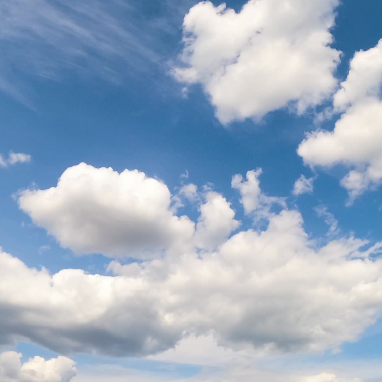 White cloudscape formation in the atmosphere. Summer sky with changing soft clouds. Low angle view timelapse