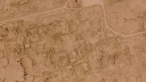 a drone shot moving forward of the ruins of jiaohe, xinjiang, by a grey day