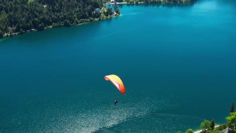 incredible aerial view of paraglider in lake bled slovenia, amazing scenery, day