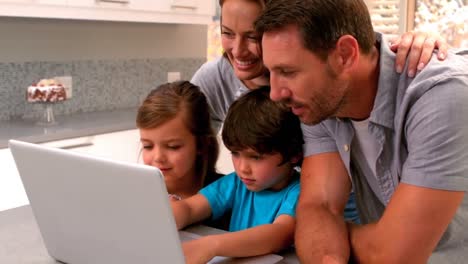 Family-using-laptop-in-kitchen