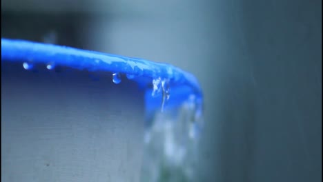 water dripping from a blue container