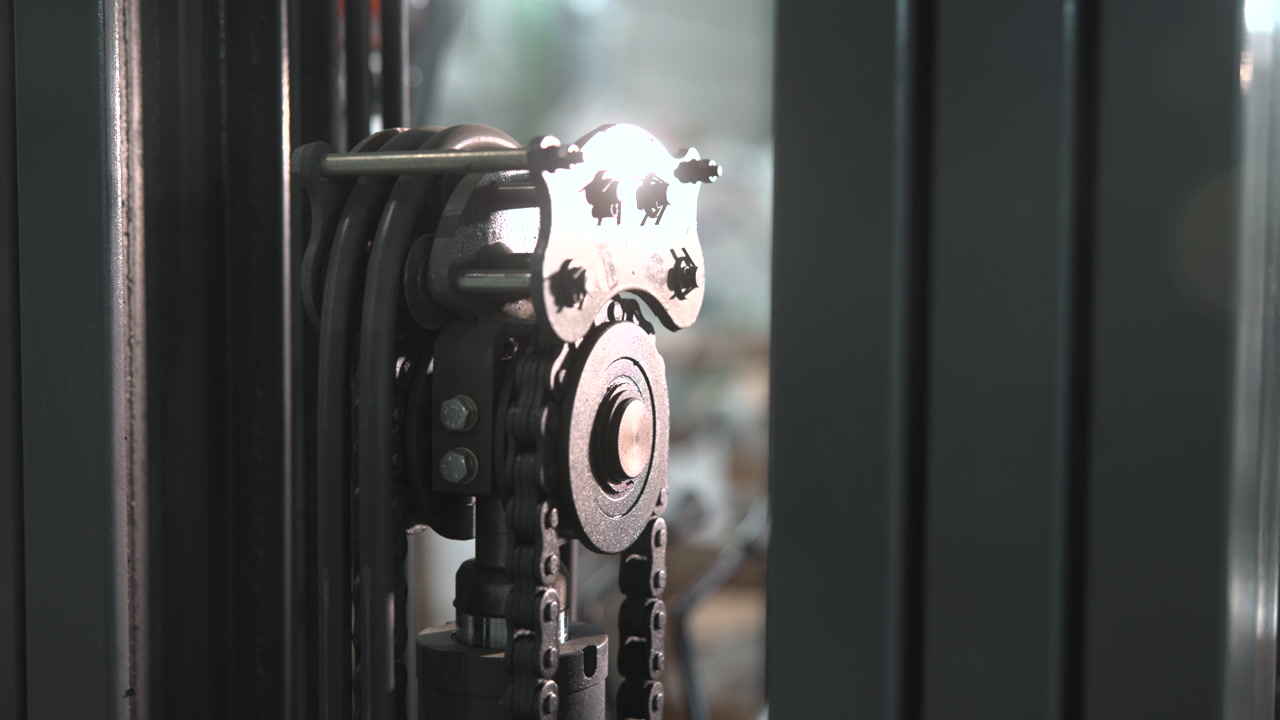 Chain Sprocket And Roller Mechanism On Mast, Close View Of Links And Bearings, Metallic Sheen And Lubricant . Media
