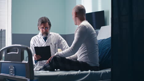 doctor discussing with patient in hospital room