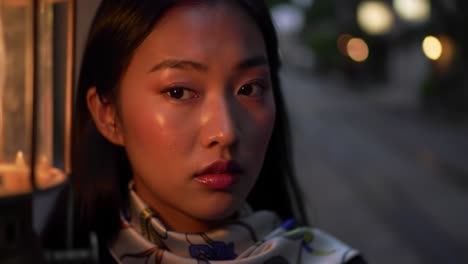 a captivating evening look: a portrait of a woman illuminated by lantern light, exuding elegance and mystery in a serene night setting