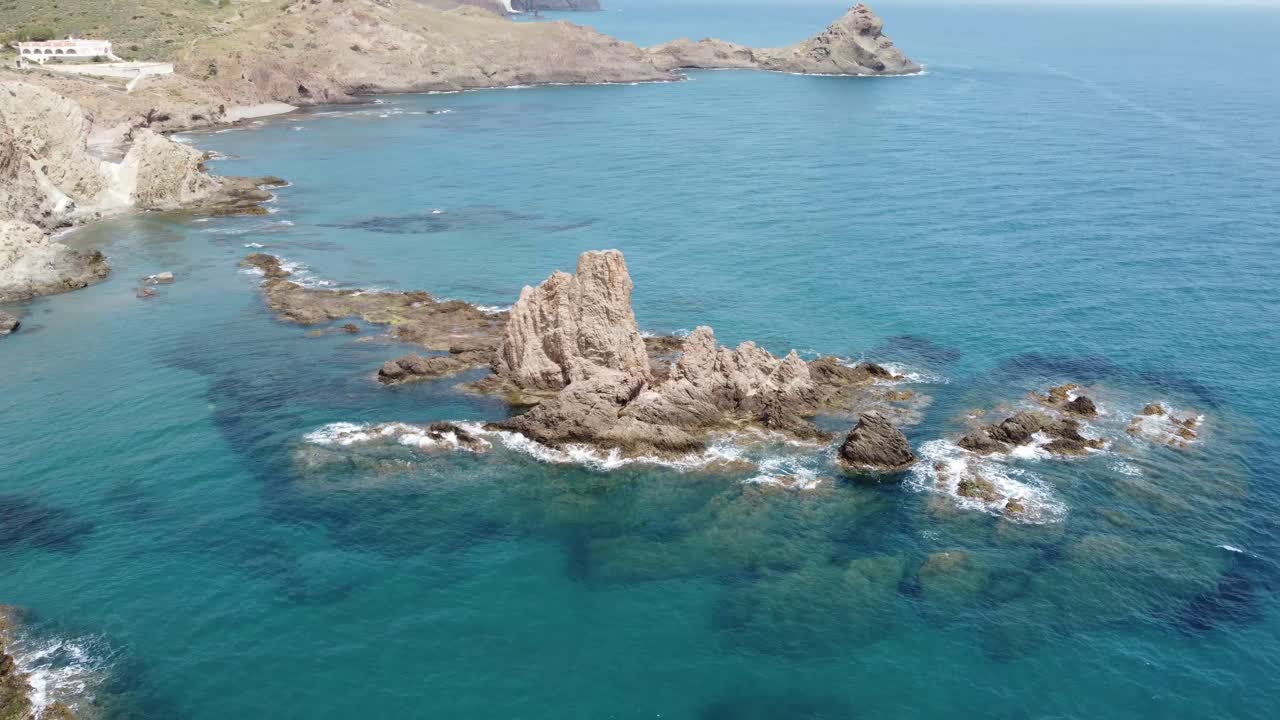 flying around a cliff in the water near the coast