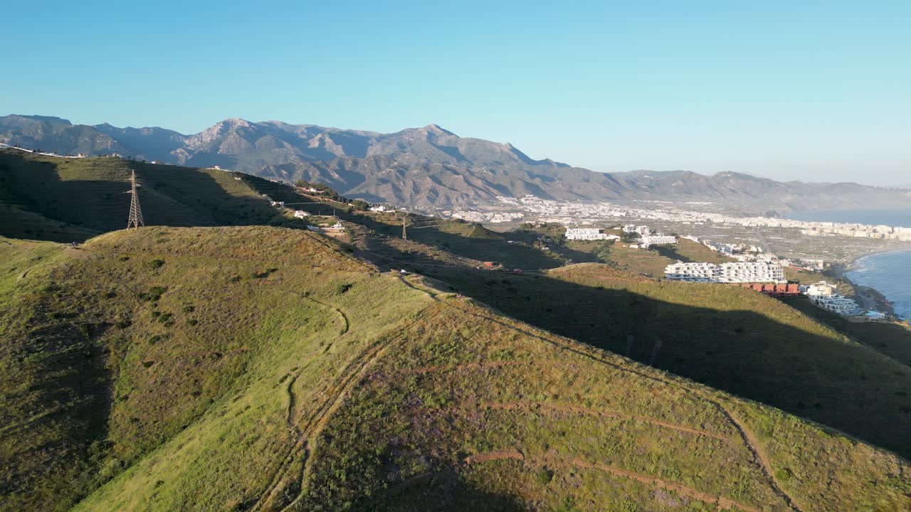 Aerial: Backwards motion with view of mountain panorama during sunset in the south of spain.