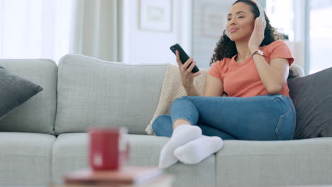 Headphones,-phone-and-happy-woman-on-couch
