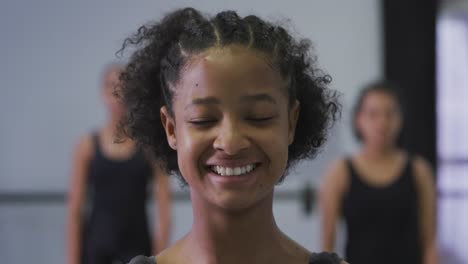 portrait of a mixed race modern female dancer looking at the camera