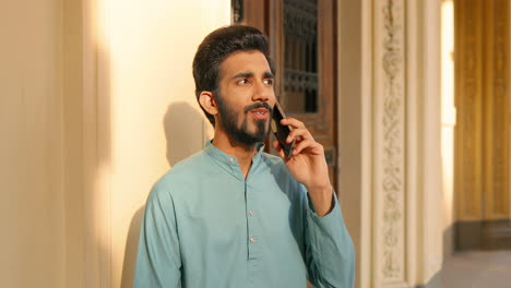 portrait of an indian man talking on the phone and smiling