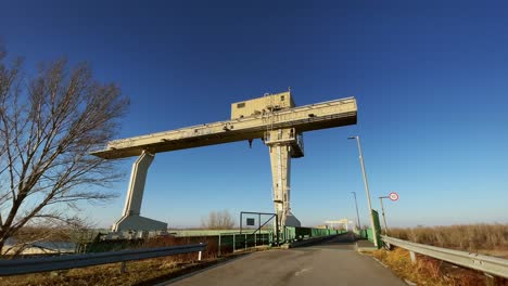 Crane-industrial-on-hydro-plant-sunny-tilt,-Mosonmagyarovar,-Hungary