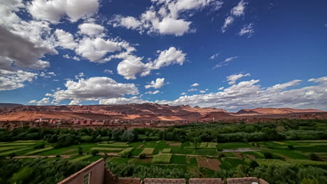 cumulus clouds float over fertile valley in morocco, africa