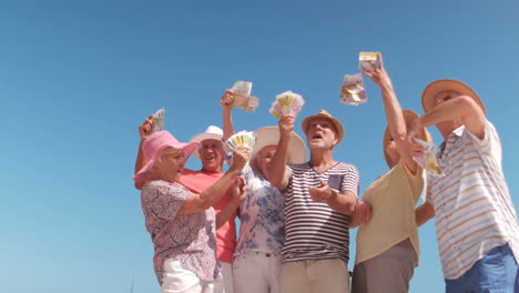 group of mature people throwing notes