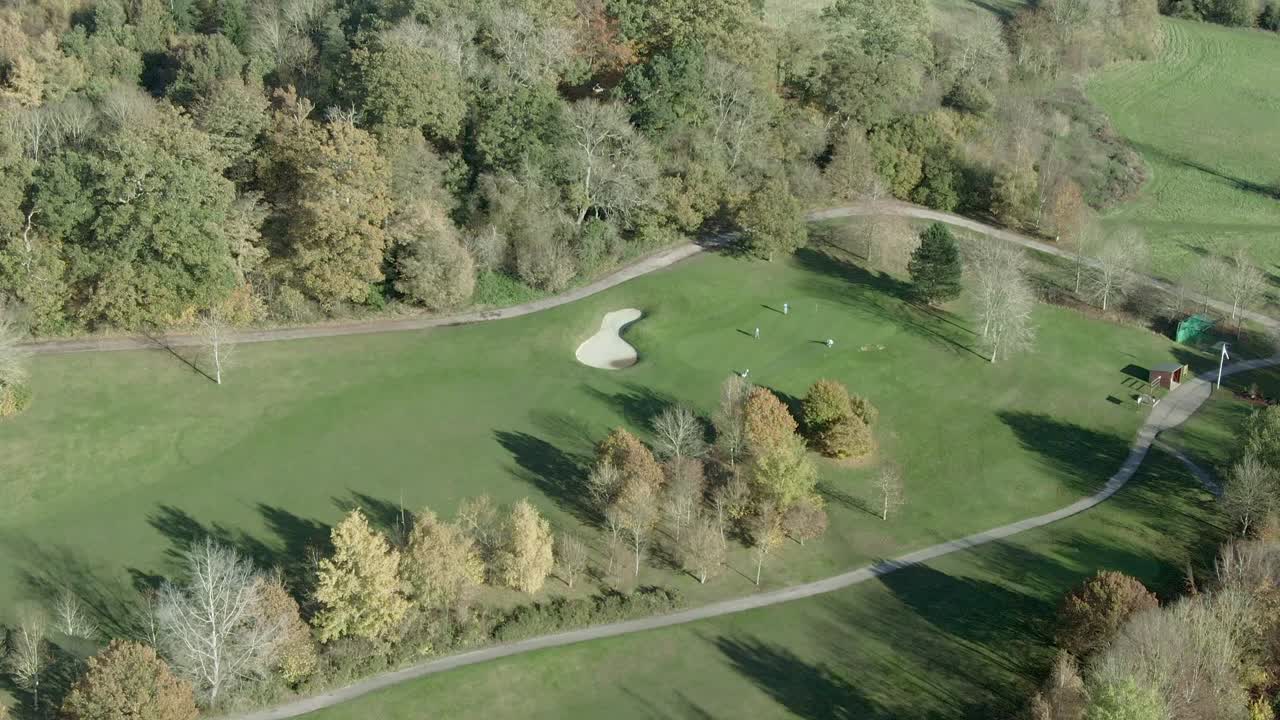 Aerial pan-up of Donnington Castle with golf course in foreground