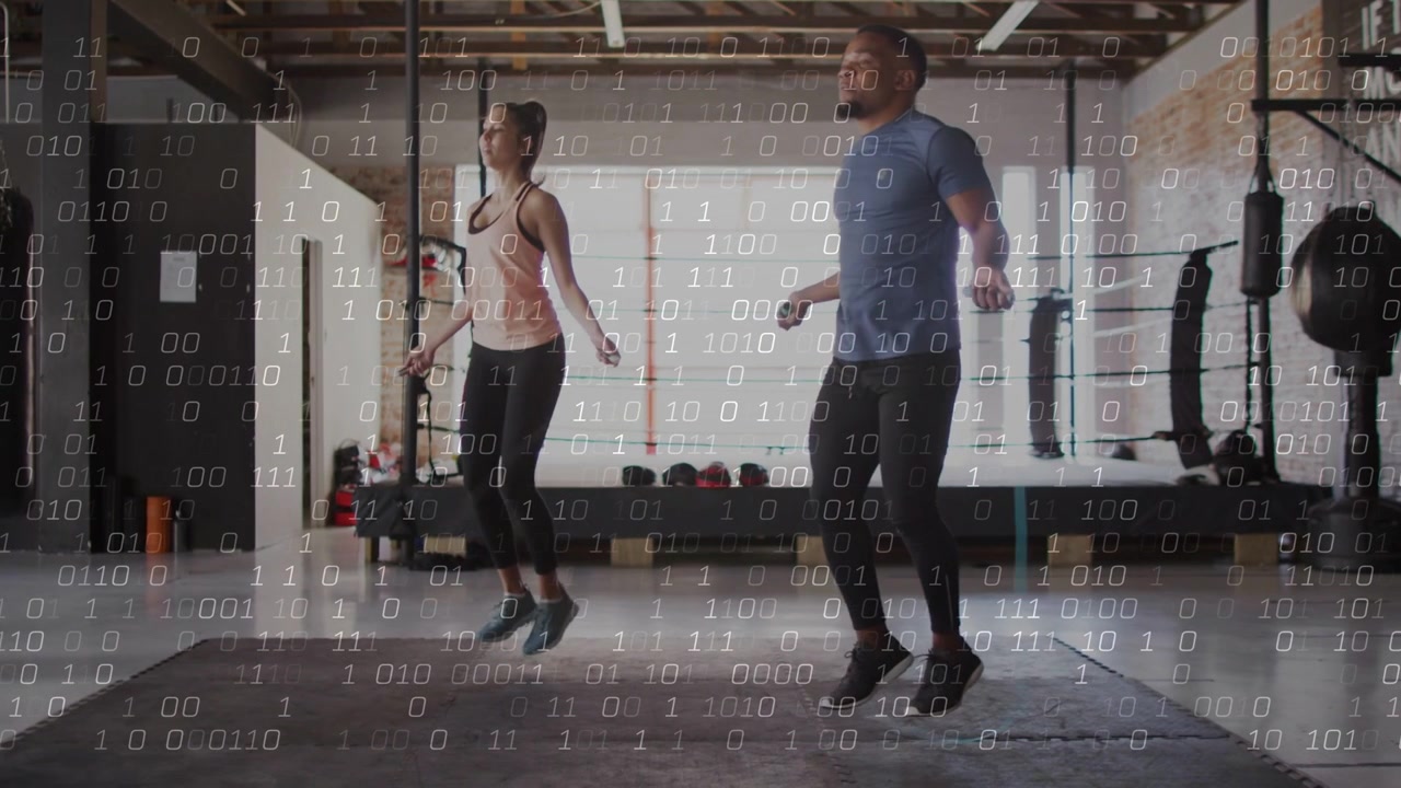 Man and woman holding ropes, synchronizing hops on gym mat for cardio, binary overlaying over duo