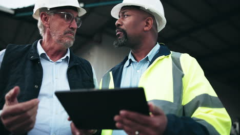 construction workers collaborating with a tablet