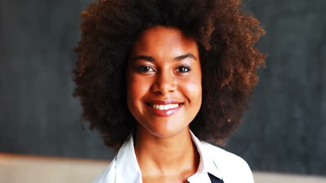 portrait of smiling waitress holding two cups of coffee