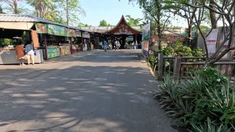 a walkway through a vibrant outdoor market.