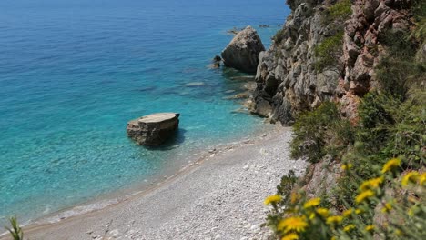 hidden beach with turquoise, clear blue water, mediterranean, reveal shot