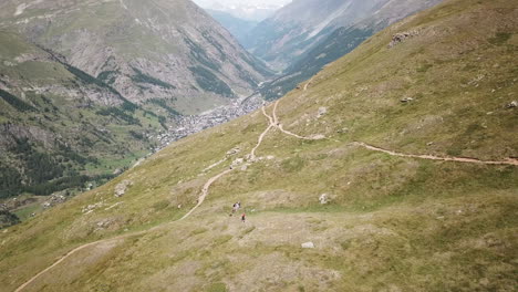 drone panning shot: landscape view on a grassery valley in the swiss alps, mountain aerial view