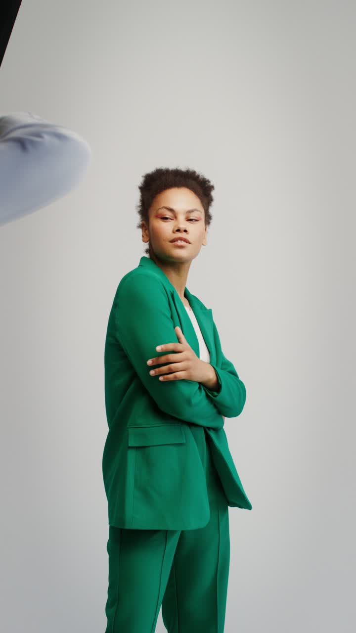 Woman in Green Suit Posing for a Fashion Shoot