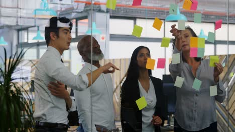 executives discussing over sticky note on glass wall 4k